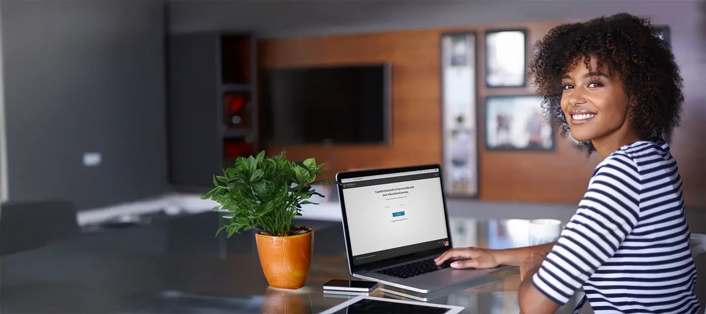 Portrayal of a Capella student at a laptop earning an online degree.