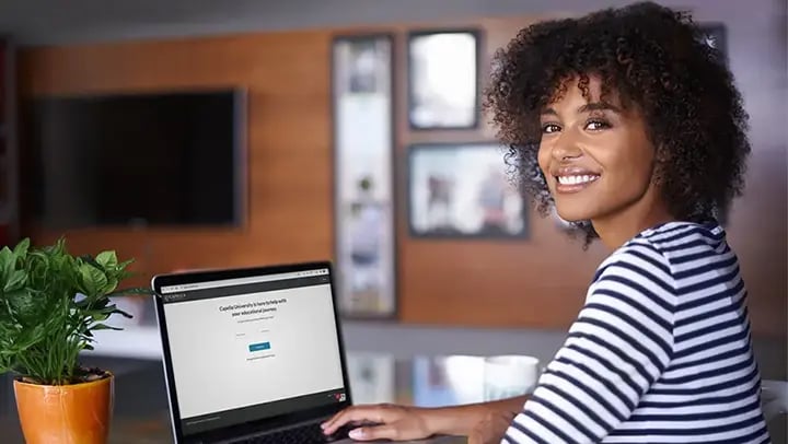 Portrayal of a Capella student at a laptop earning an online degree.