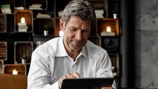 man looking at a tablet