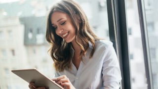 smiling woman on tablet