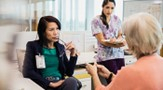 Health administrator listening attentively to woman