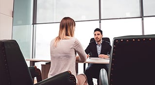 Two work colleagues in a discussion over a desk