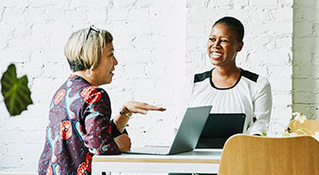 Two women at a desk