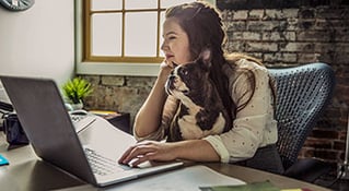 Woman with braid at desk with laptop