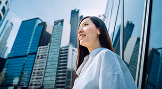 Woman in city looking up