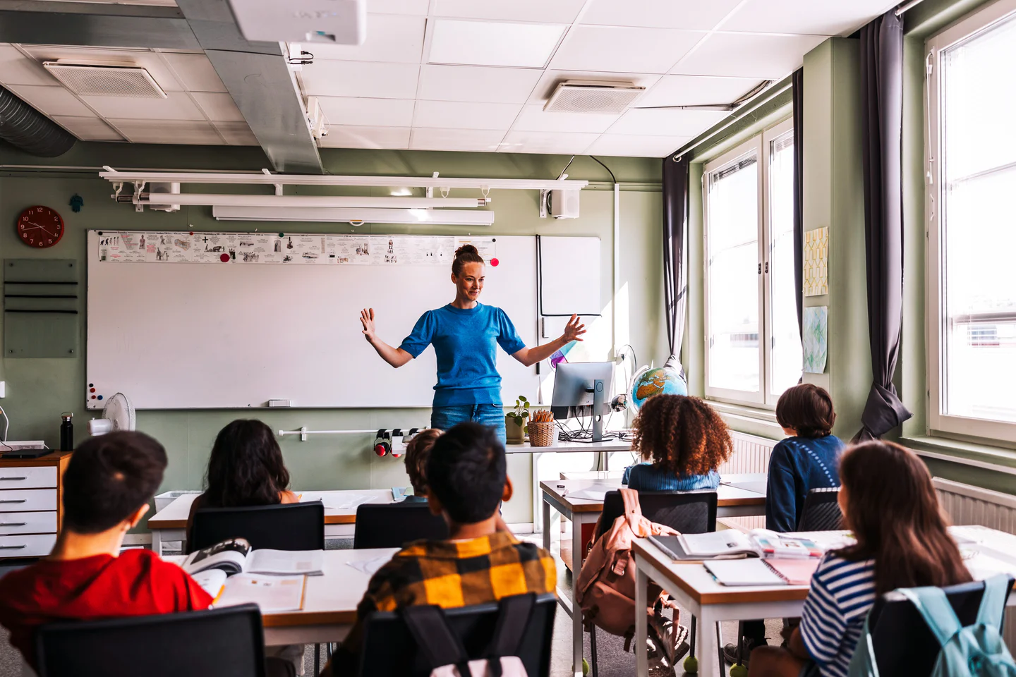 woman teaches full classroom