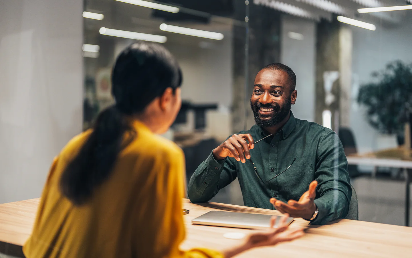 Portrayal of Capella students seated and talking at a conference table.