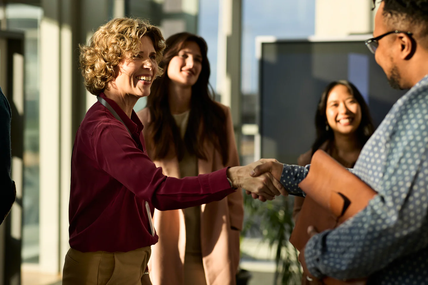 Portrayal of a&nbsp;Capella University&nbsp;online&nbsp;graduate student shaking hands with a colleague.