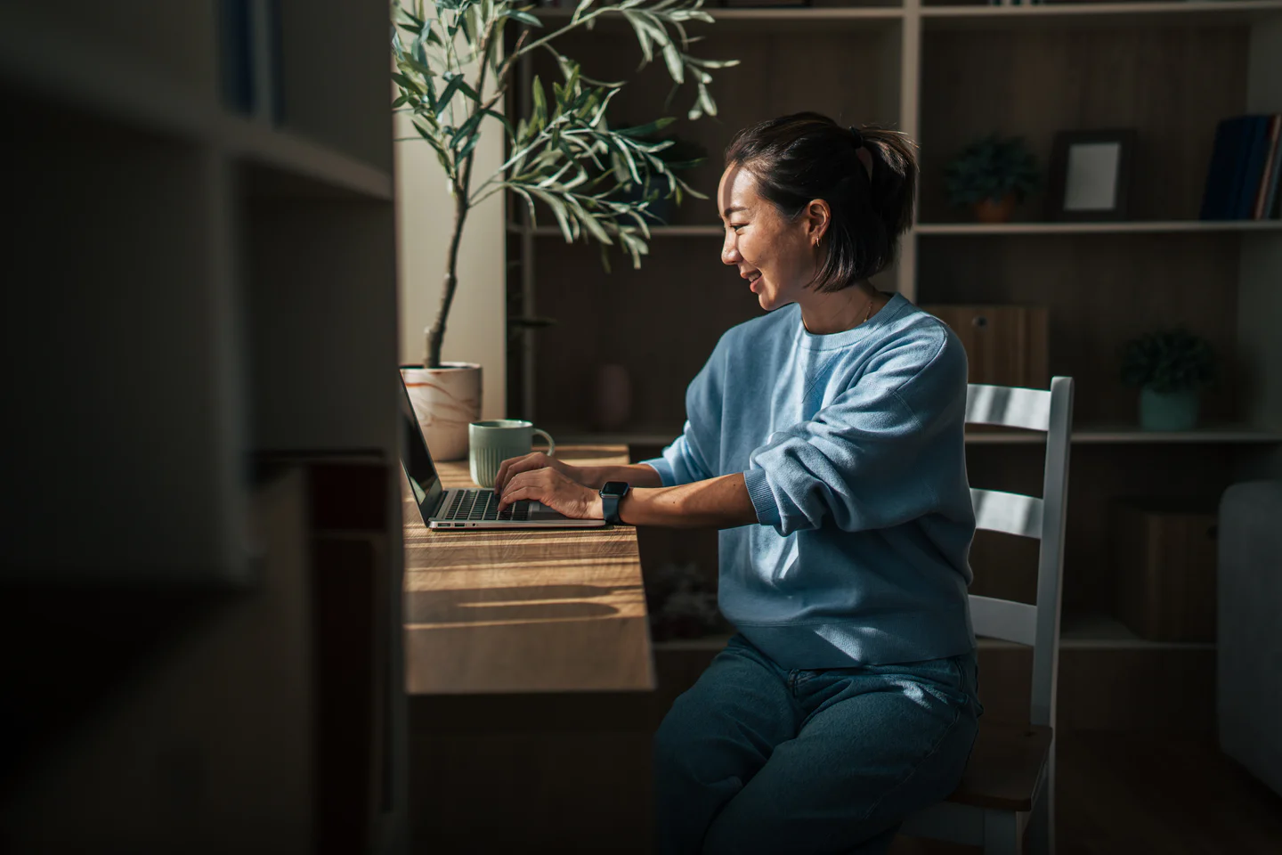 Portrayal of Capella student working at laptop in home office.