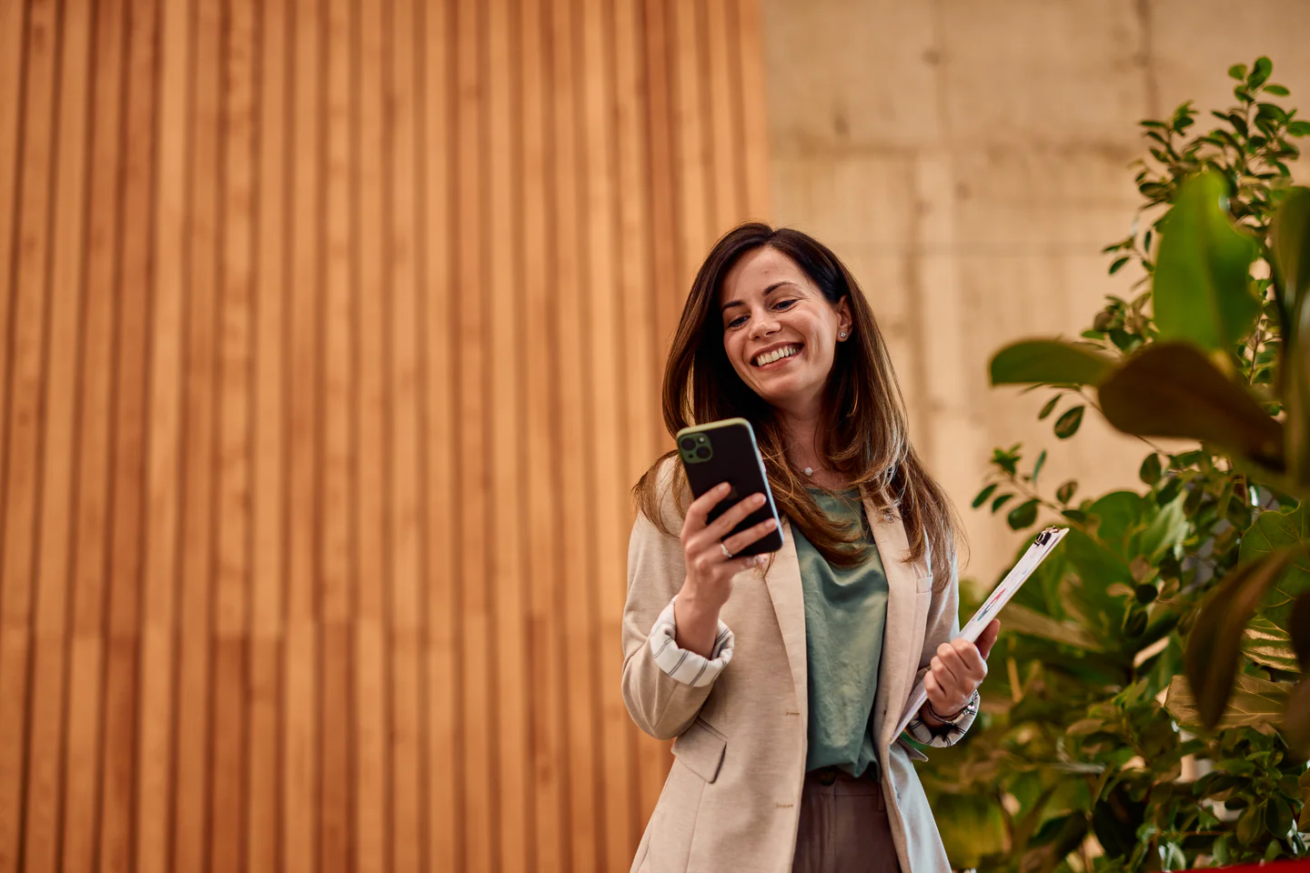 Portrayal of Capella student smiling while checking phone.