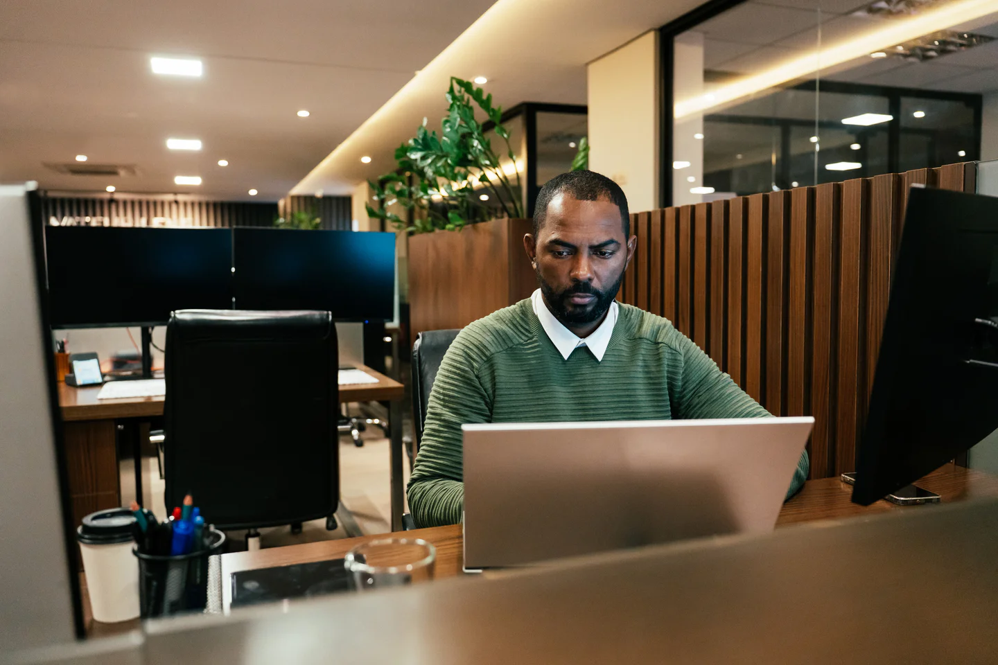 Portrayal of Capella IT student working on a computer in an office.