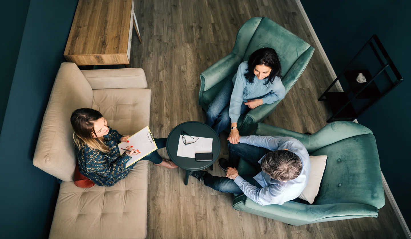 Portrayal of a Capella University psychology alumni counseling a couple.