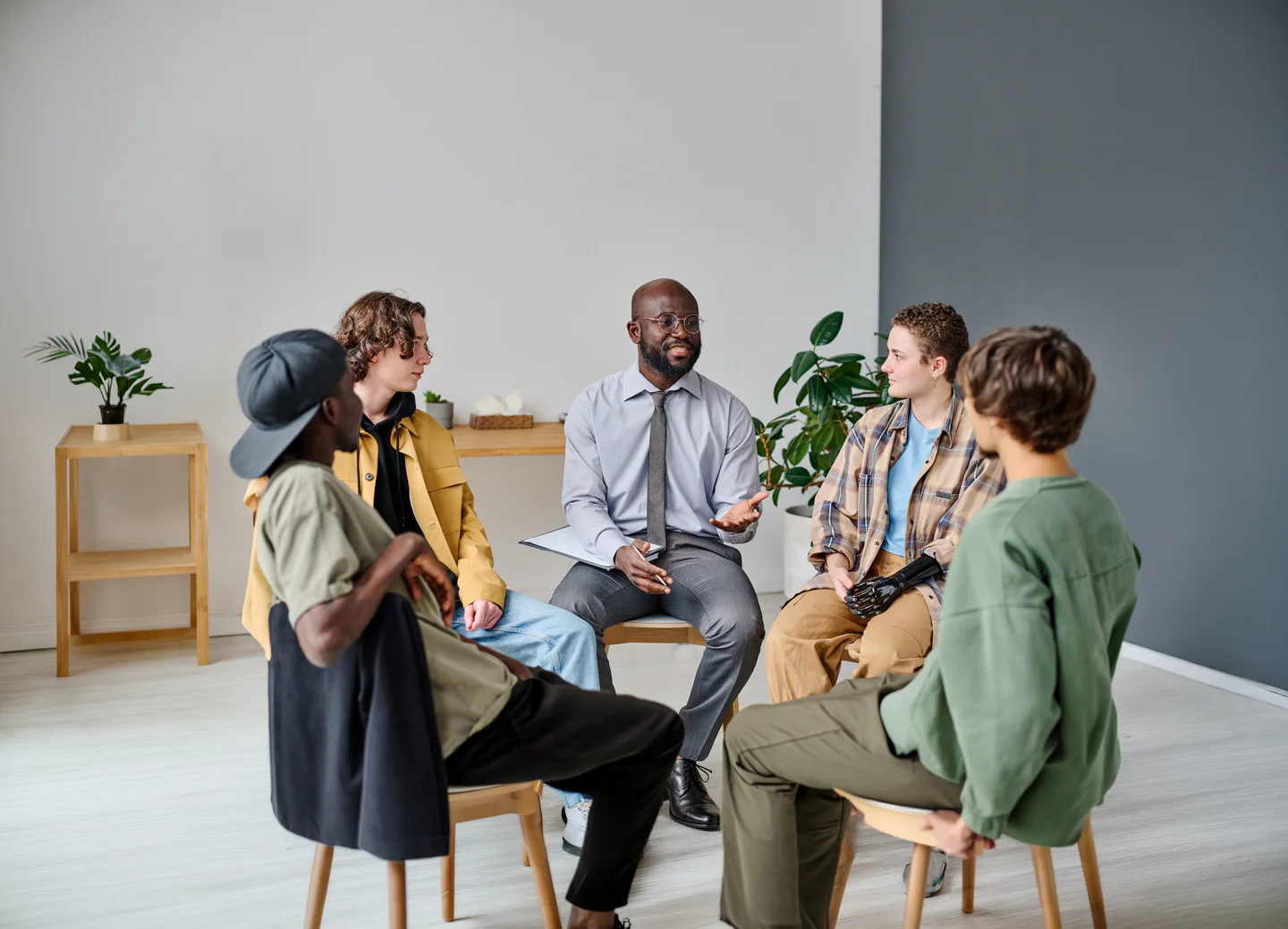 Portrayal of a Capella University online&nbsp;therapy alum counseling&nbsp;a group&nbsp;of teenage boys.