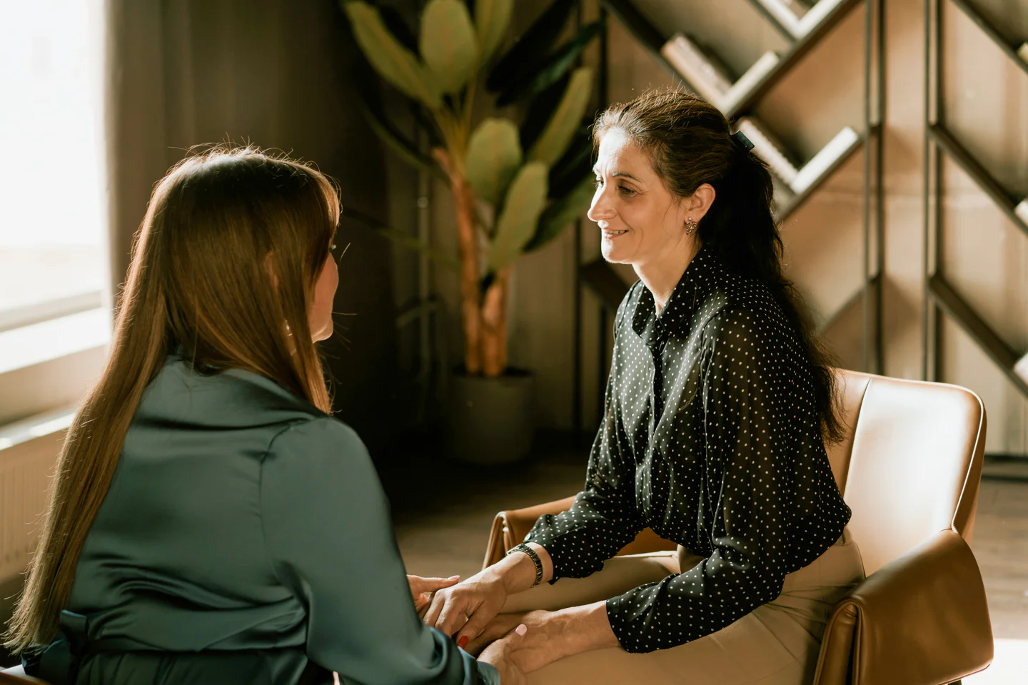 Woman Therapist in green conforts patient