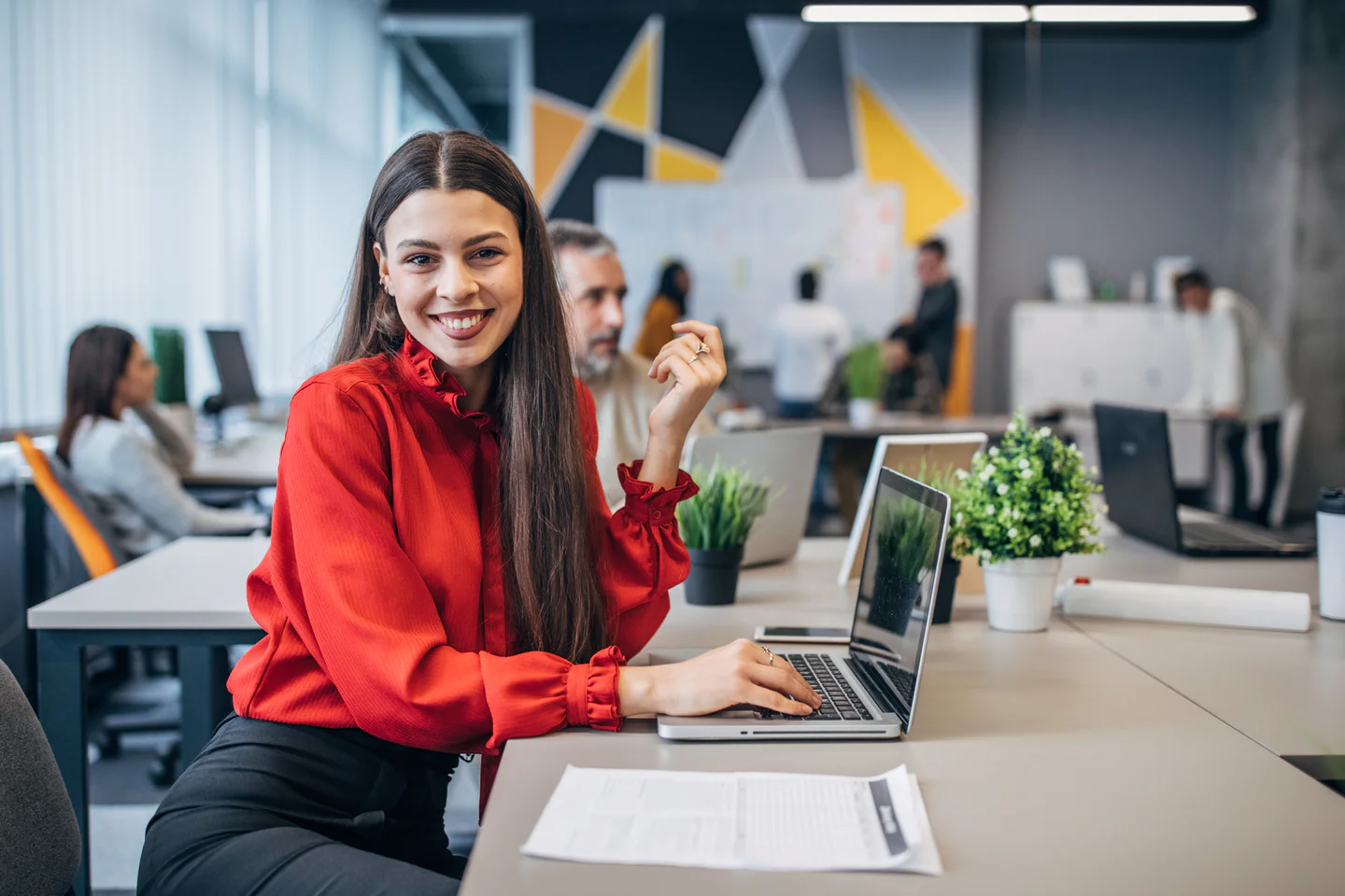 Portrayal of Capella business student in an open office setting.