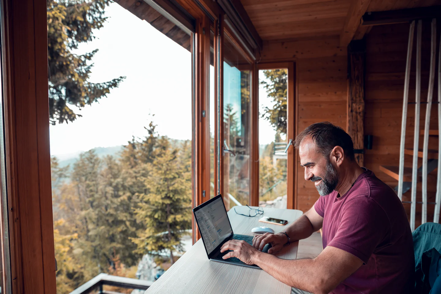 Portrayal of Capella online student studying in a cabin.