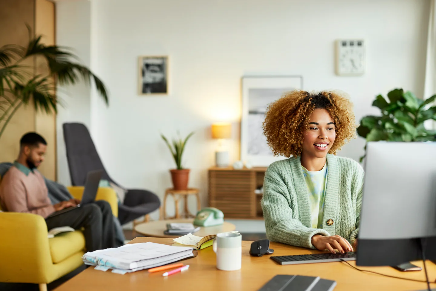 Portrayal of Capella online student using a computer in her home office.