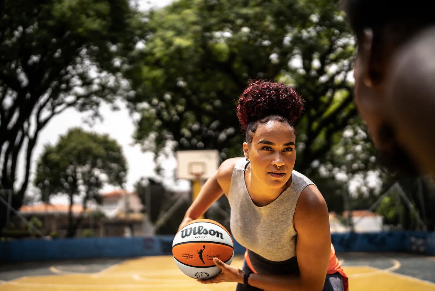 Portrayal of a woman playing basketball on an outdoor court