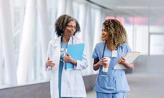 two nurses talking in a hallway