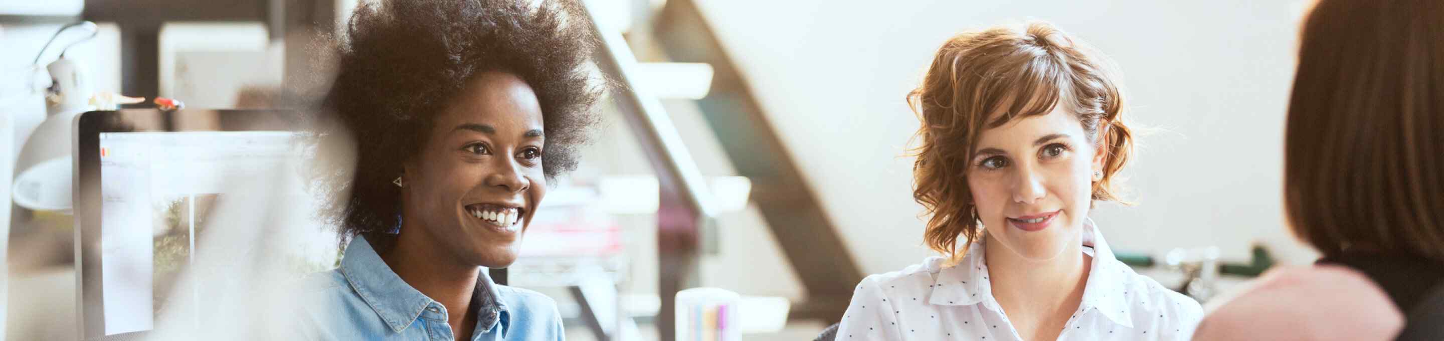 three women talking and smiling
