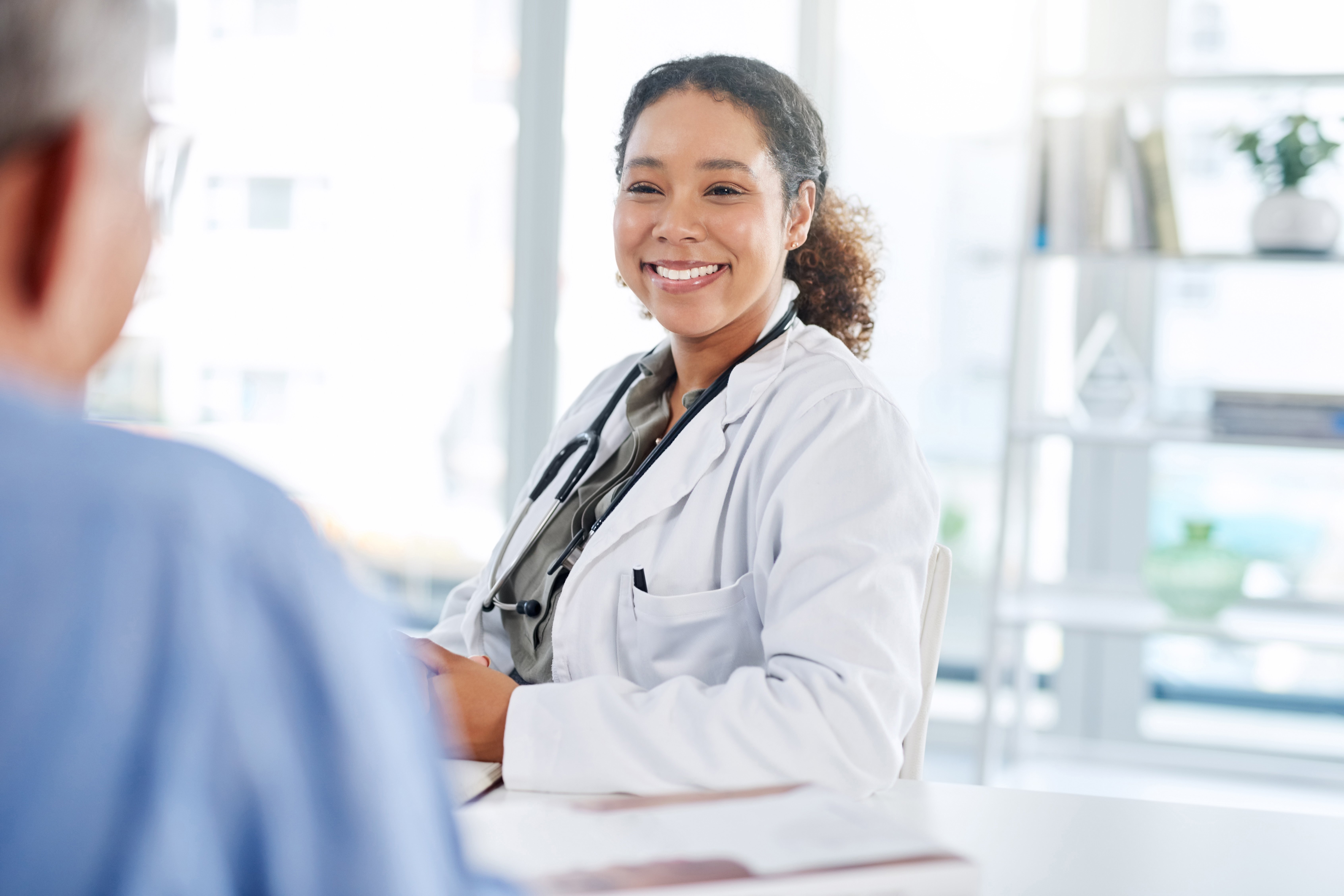 Portrayal of a doctor smiling at a Capella University online nursing student