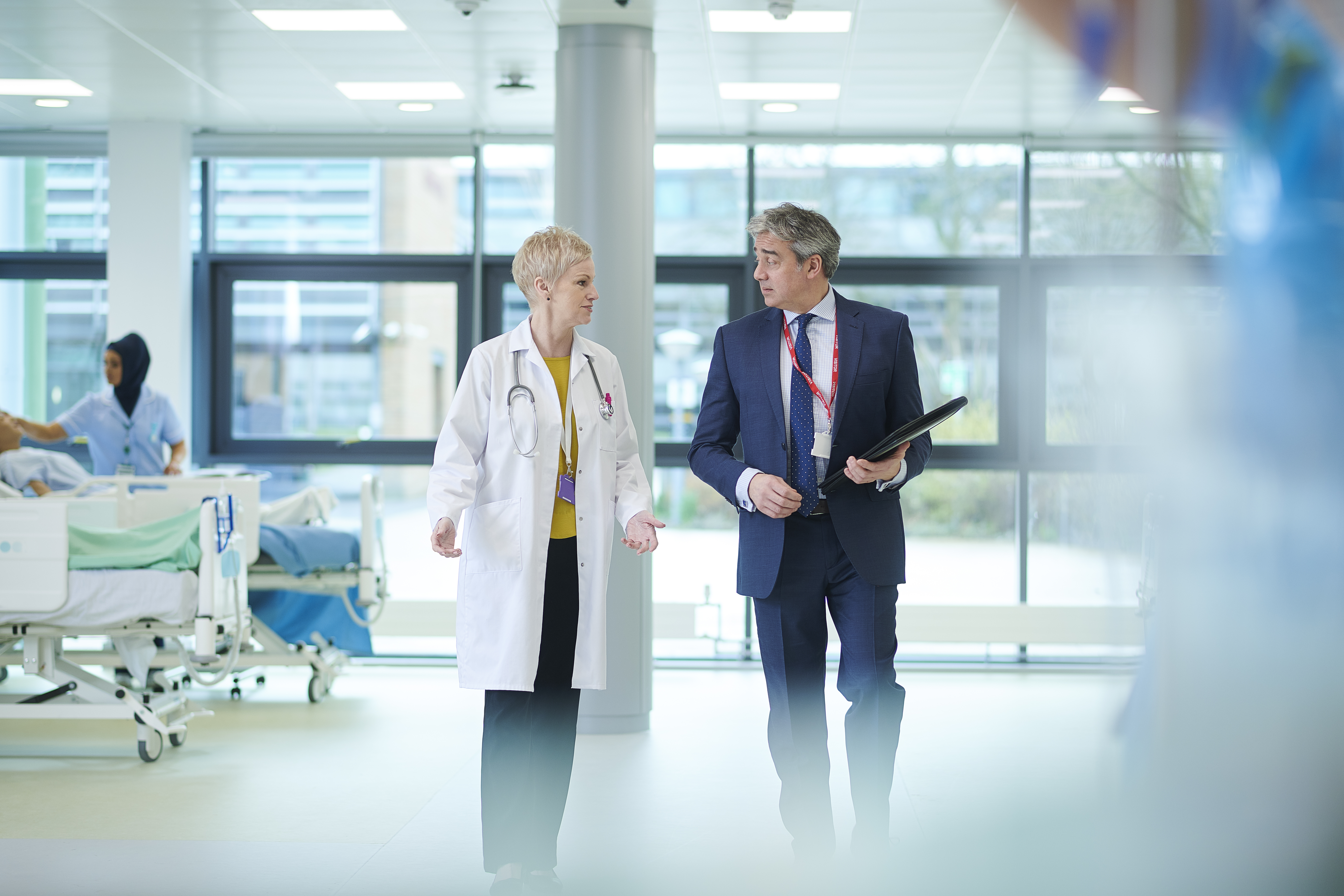 Portrayal of doctor talking with hospital healthcare administrator.