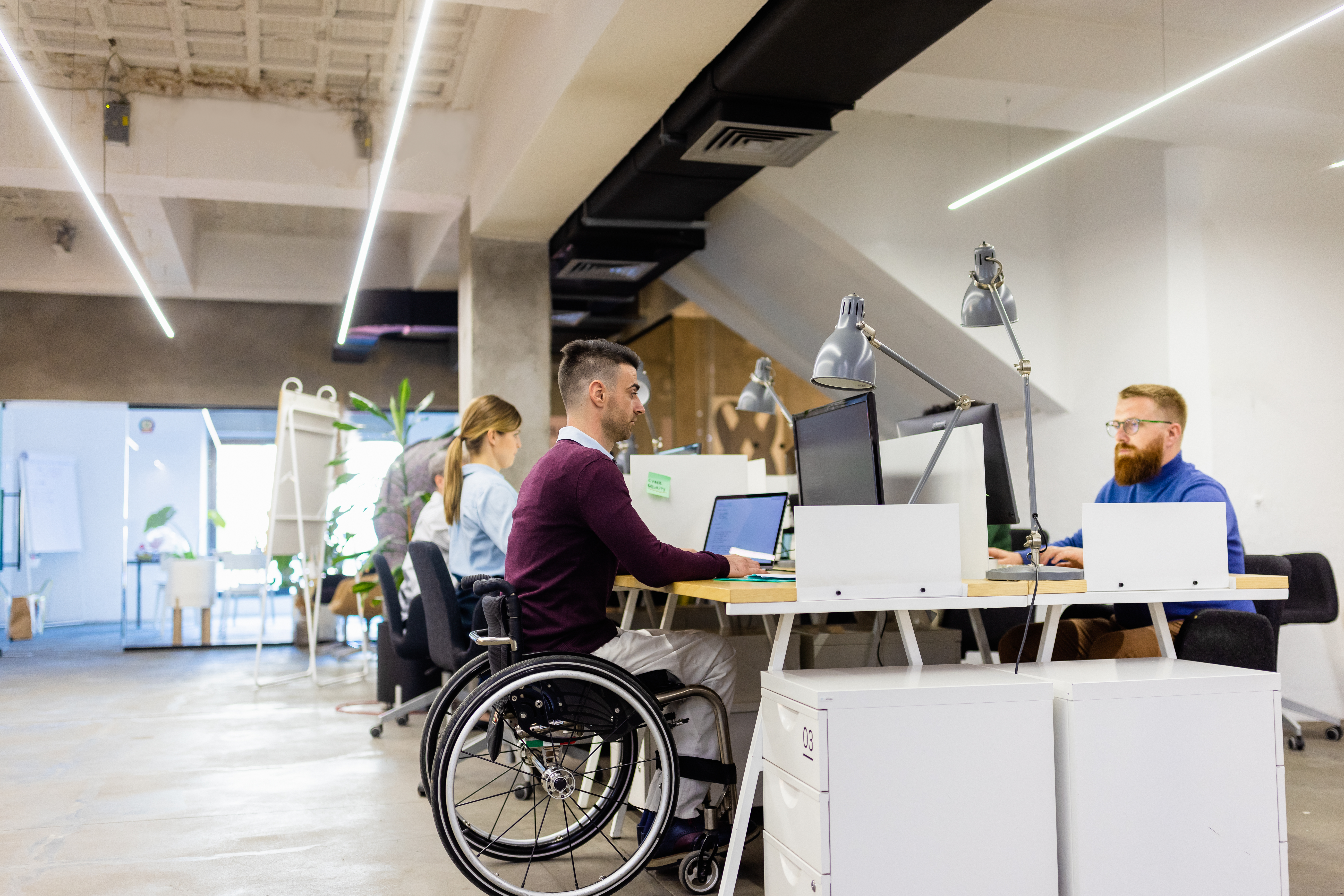 Portrayal of Capella IT student in open office environment.