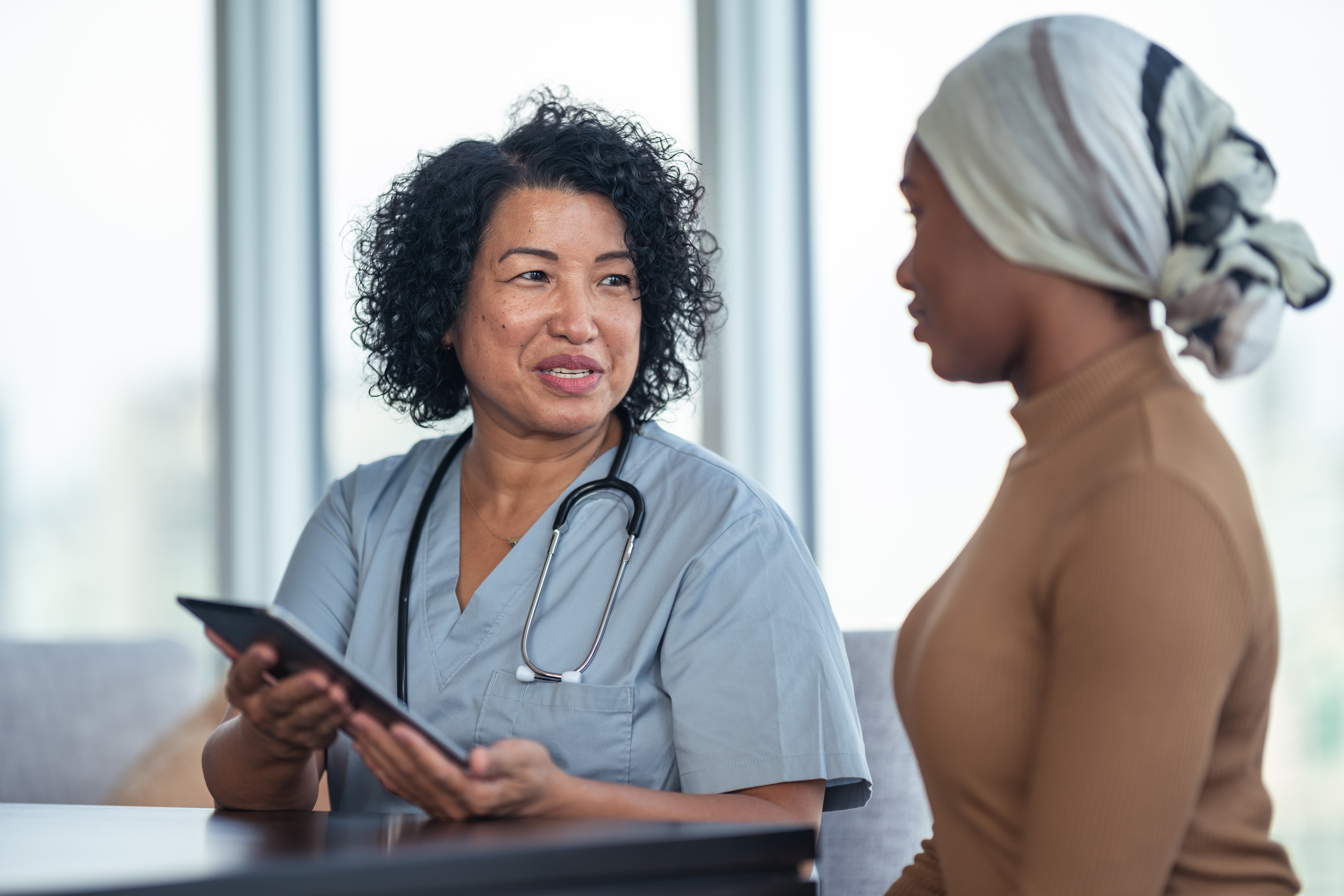 Portrayal of a Capella University online nursing degree graduate consulting with a patient