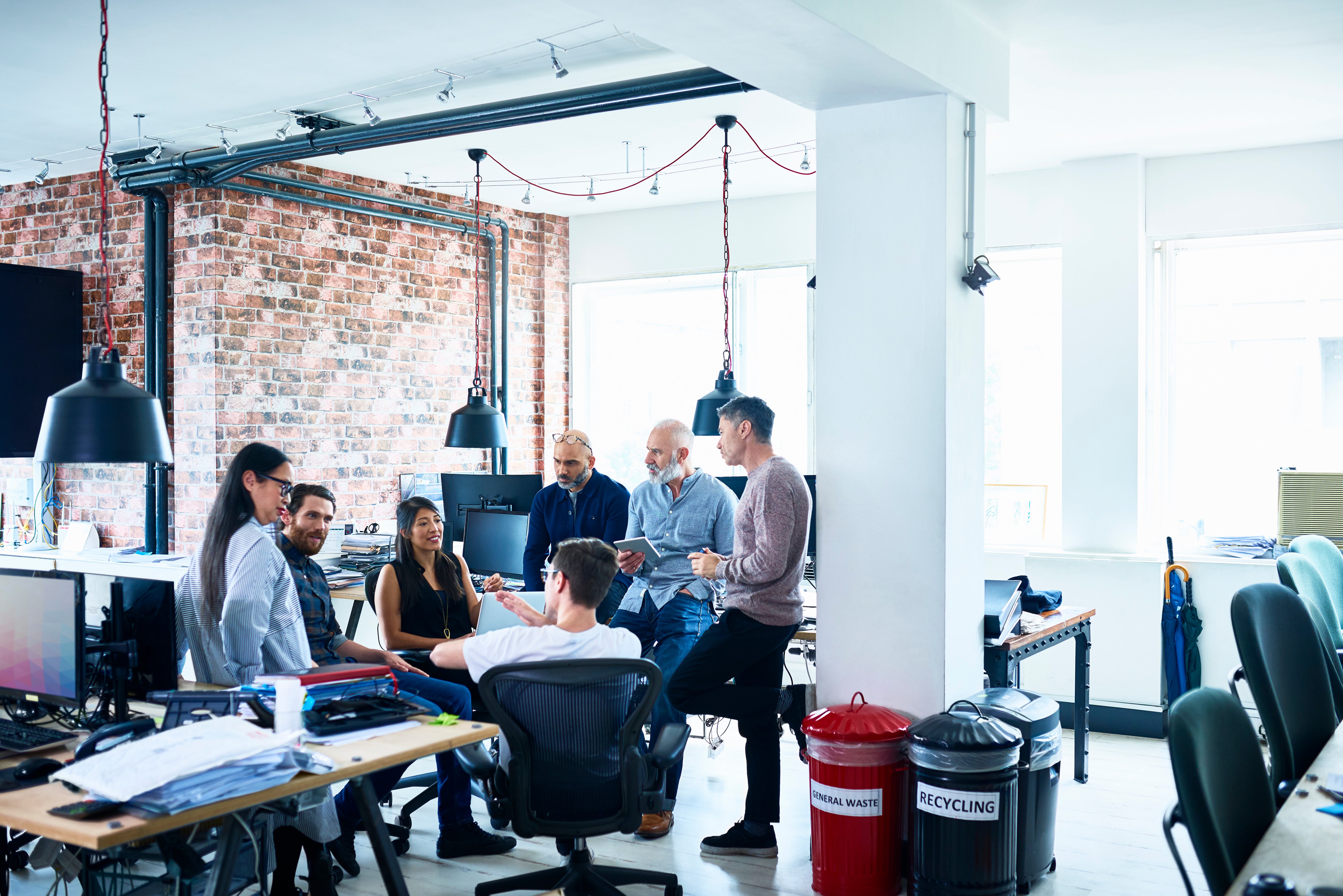 Portrayal of Capella business management student building consensus with colleagues