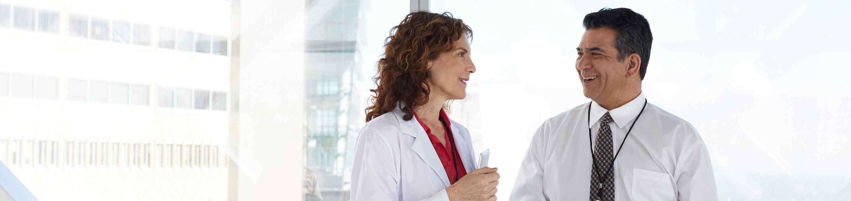 a male doctor talking to a female doctor