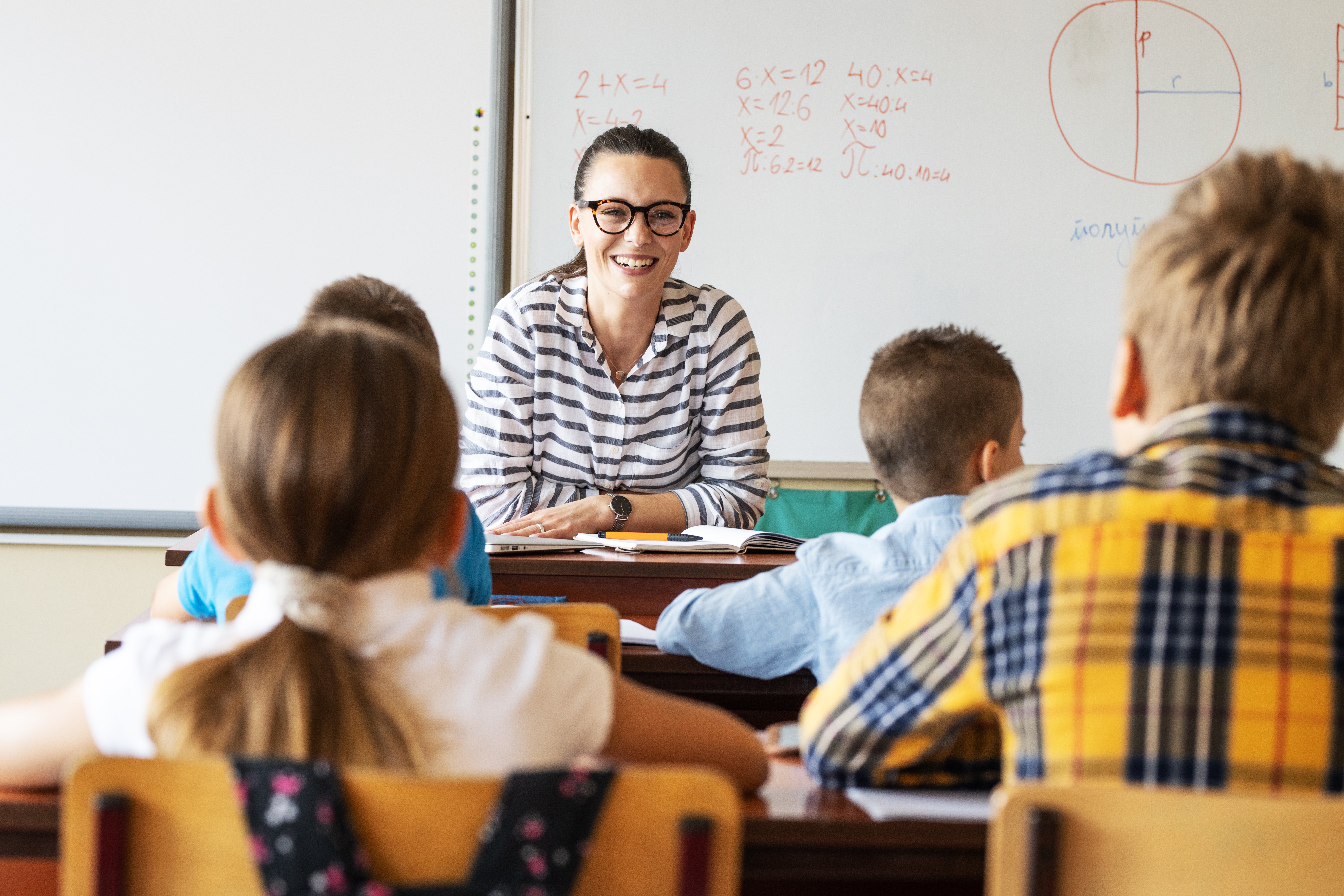 Portrayal of a Capella University online education graduate teaching in a classroom