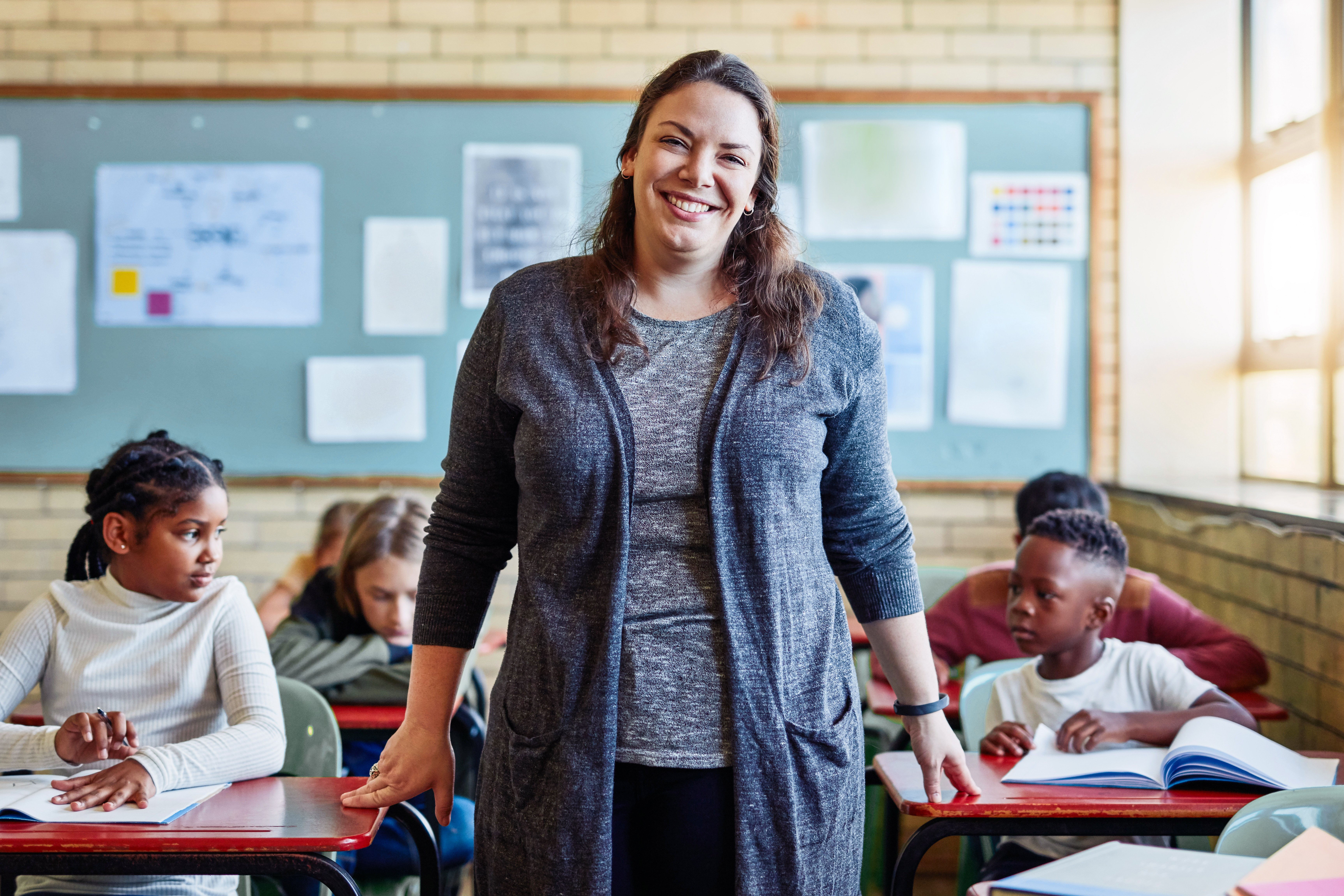 Portrayal of a Capella University online education graduate teaching in a classroom