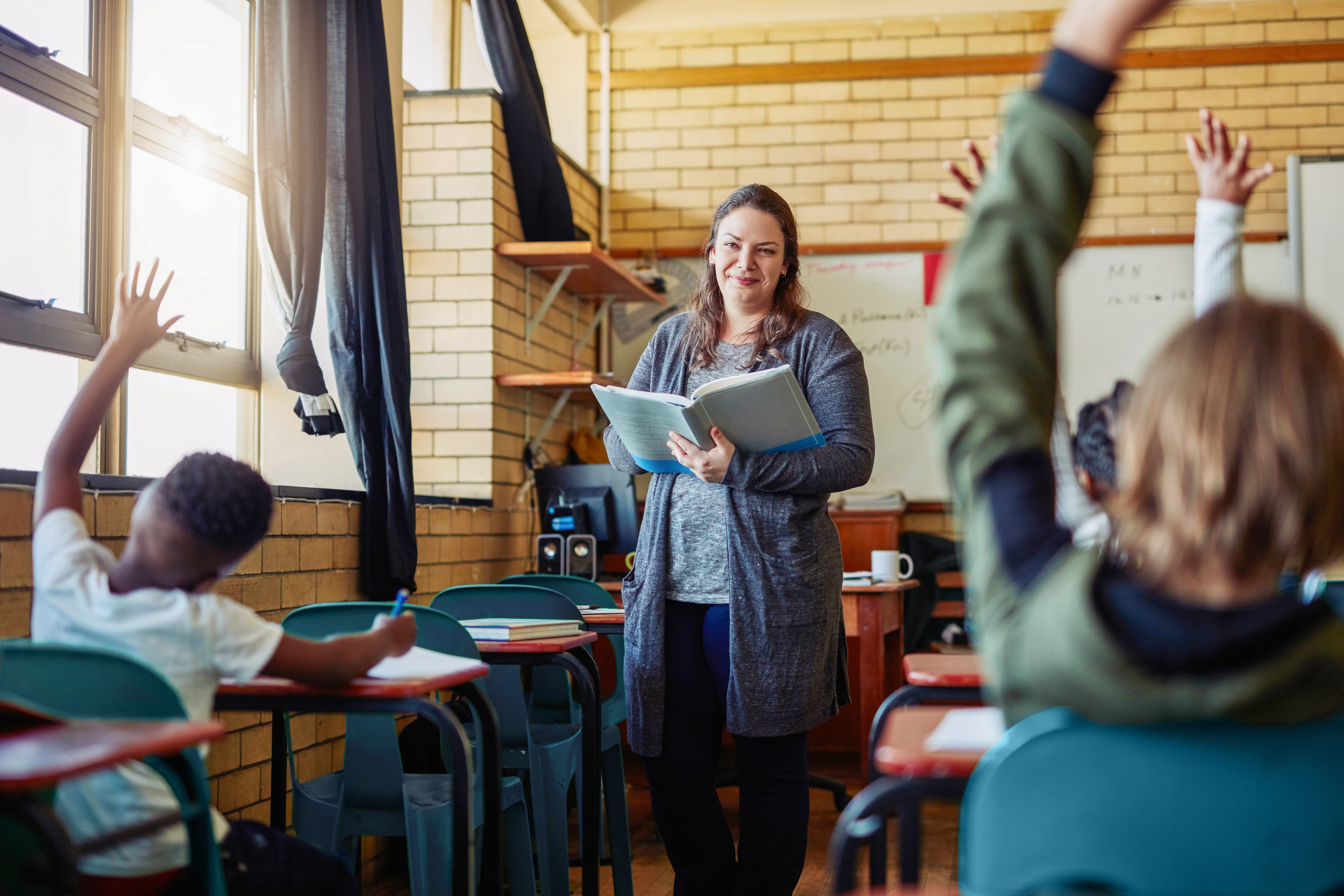 Portrayal of a Capella University online education alum teaching in a classroom