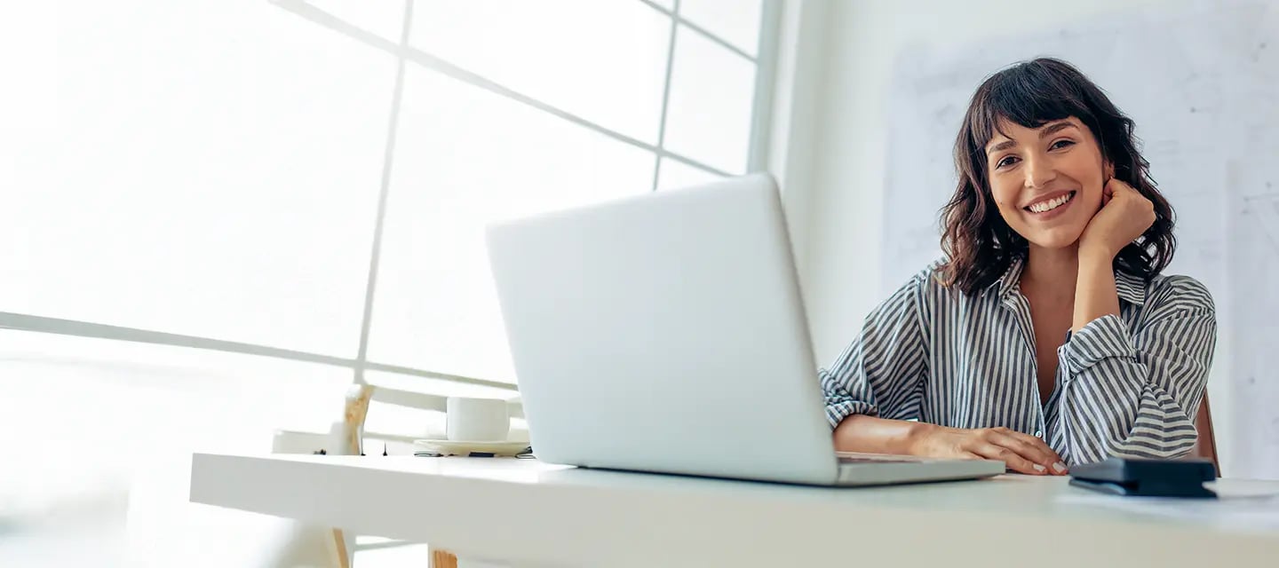 Portrayal of a Capella student using a laptop to earn a competency-based education.