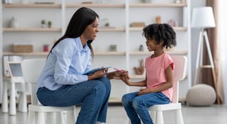  woman teaching young girl