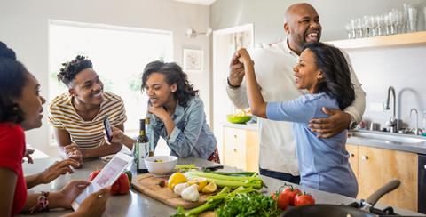 Group of family dancing in kitchen