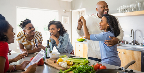 Group of family dancing in kitchen