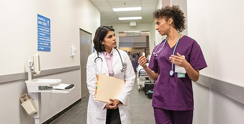 nurse and doctor talking in the hallway