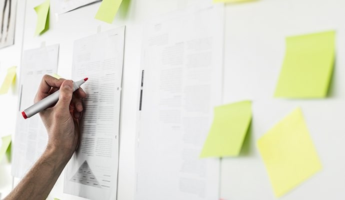 hand writing on note taped on wall